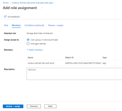 A screenshot showing the completed Add role assignment page and the location of the Review + assign button used to complete the process.