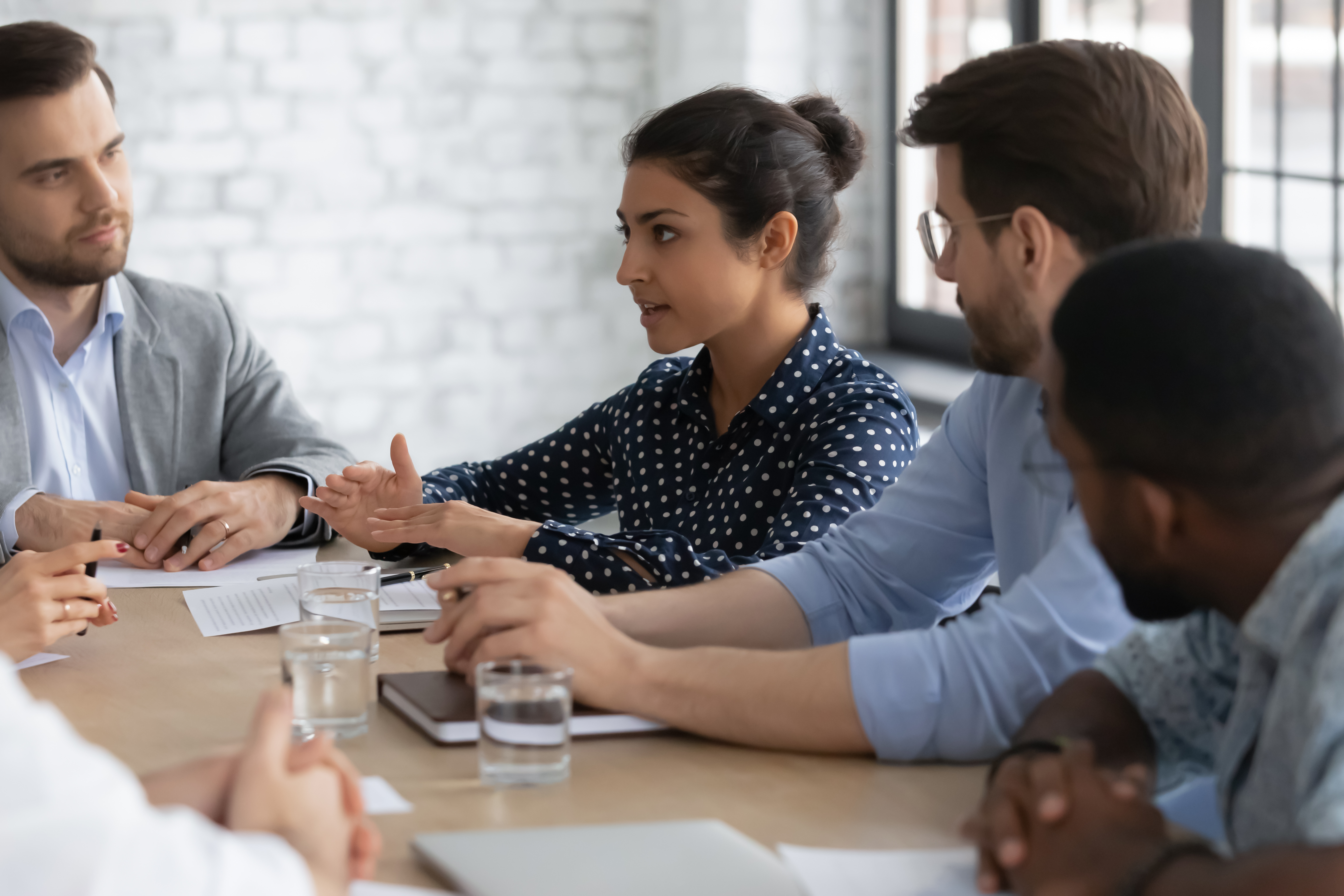 A photograph of a group of diverse people in a meeting.