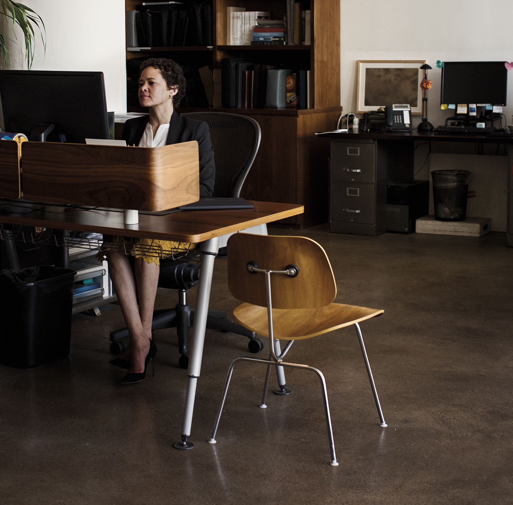 A photograph of a woman working on her computer.