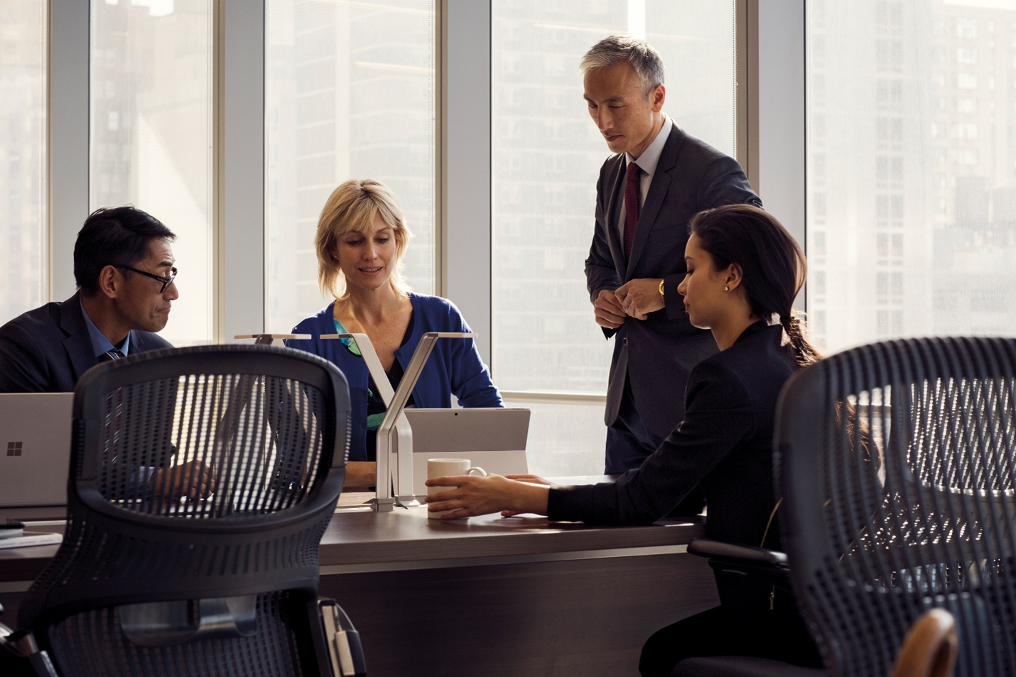 A photograph of diverse group of people in a meeting.