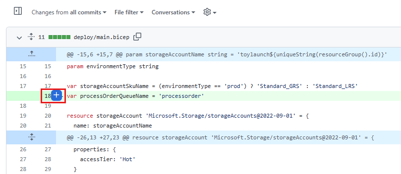 Screenshot of GitHub that shows changes to the main dot bicep file. The mouse is hovering over line 18, and the button for adding comments is highlighted.