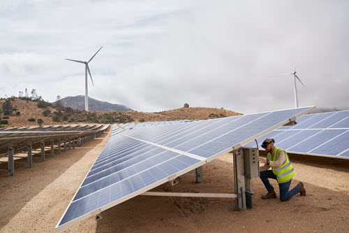 Photograph showing of people working on solar panels.